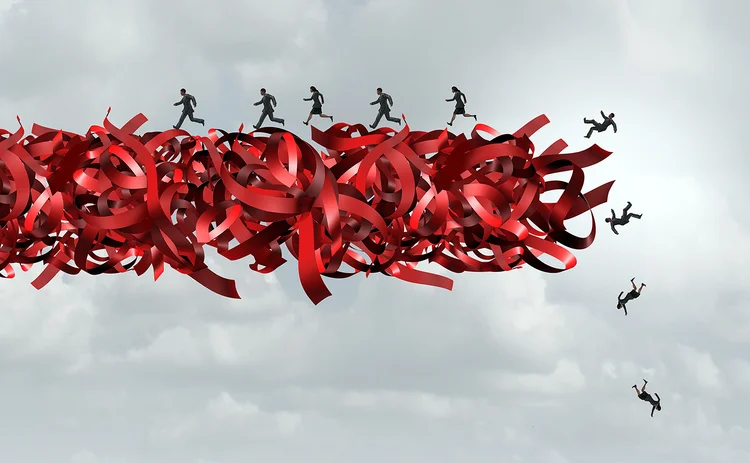 Employees falling from shredded red tape line - concept